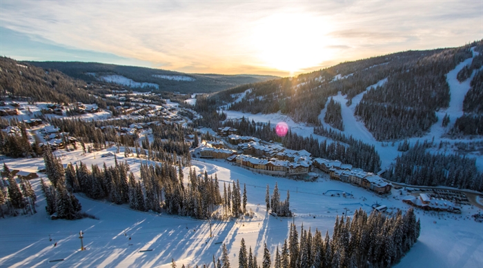 Sun Peaks newspaper hit with $10,000 foreign worker program fine | iNFOnews.ca An aerial view of a village below a mountain ski resort.