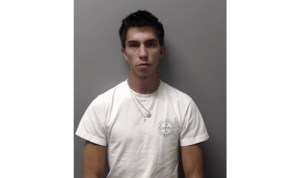 Brown haired man in a white shirt.