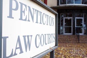A sign that reads Penticton Law Courts outside the doors of courthouse.