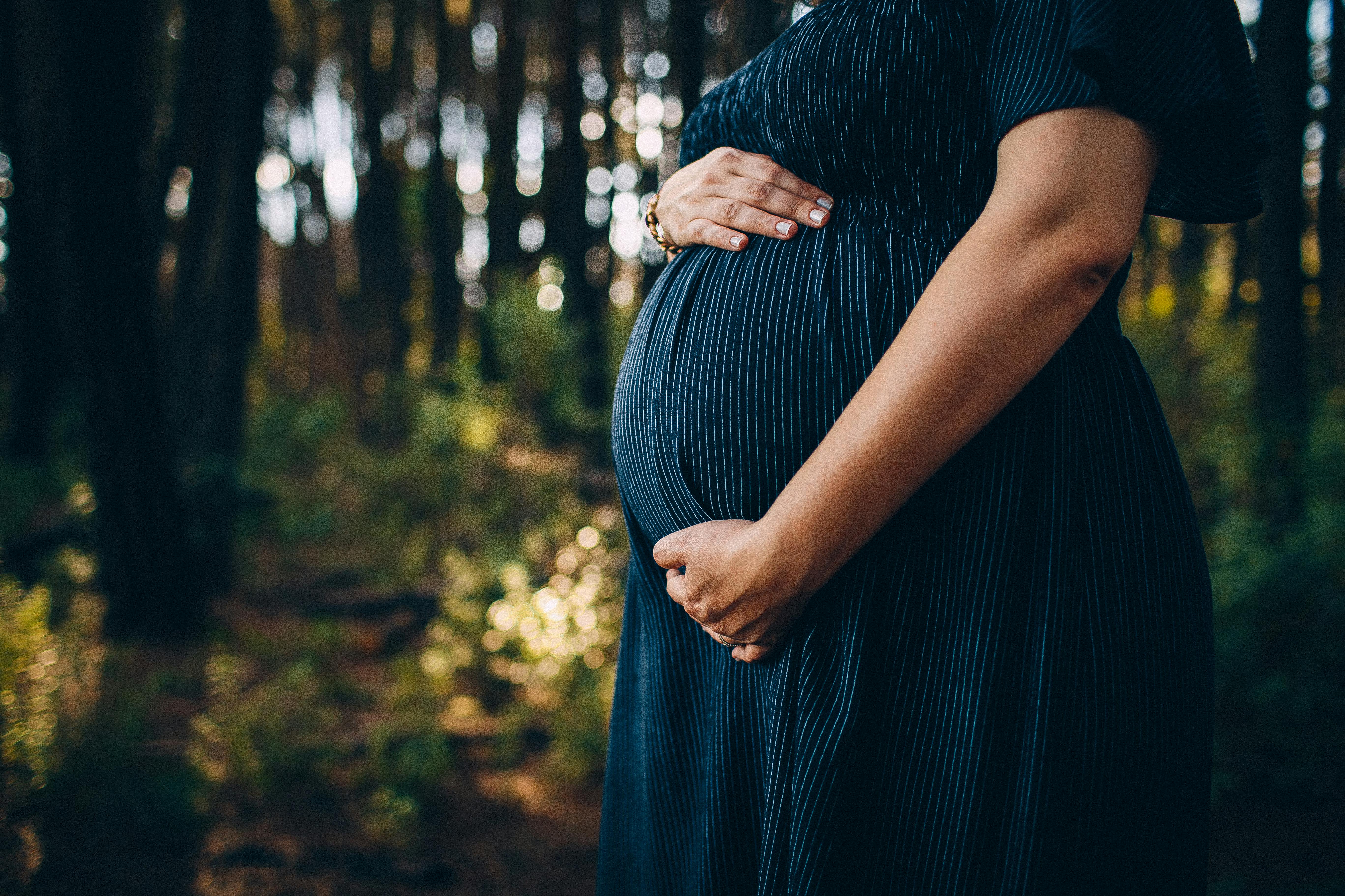 Kamloops company that downgraded employee after mat leave to pay $22K | iNFOnews.ca A pregnant woman holds her belly.