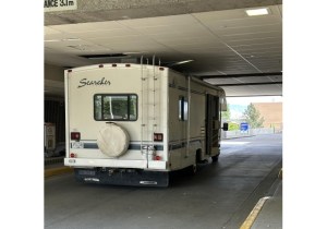 An RV stopped in a drive-thru entrance where it struck the ceiling.