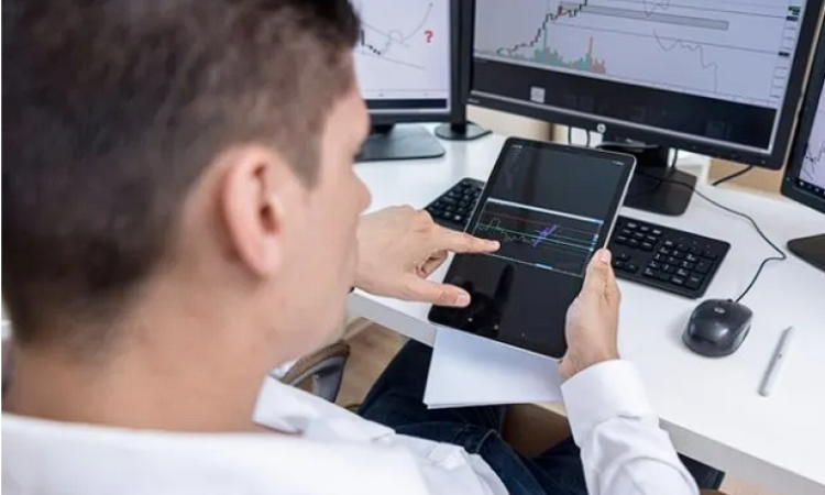 A stock trader viewing a chart on a tablet.