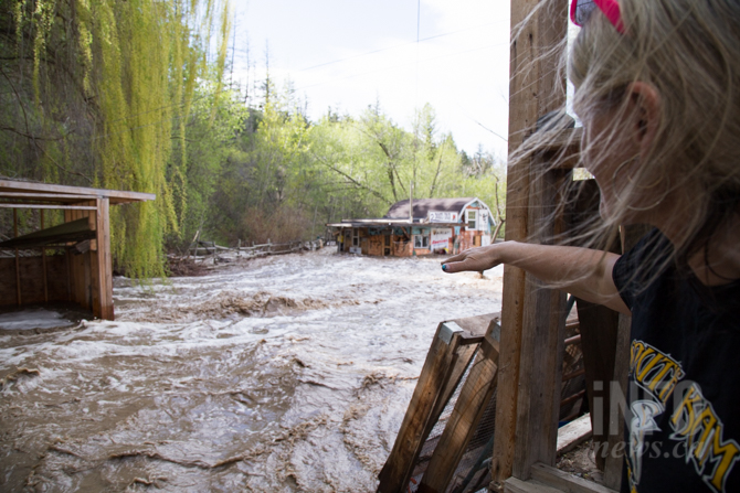 Court dismisses effort to blame Public Guardian for Kamloops area flood damage | iNFOnews.ca Woman looking at property damaged by flooding.